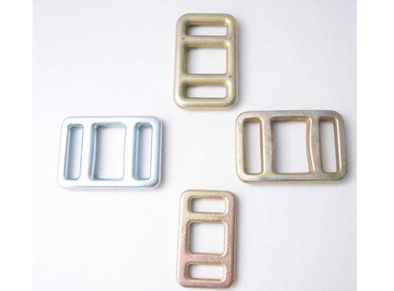 Four rectangular three-slot steel lashing buckles with silver and gold finishes.
