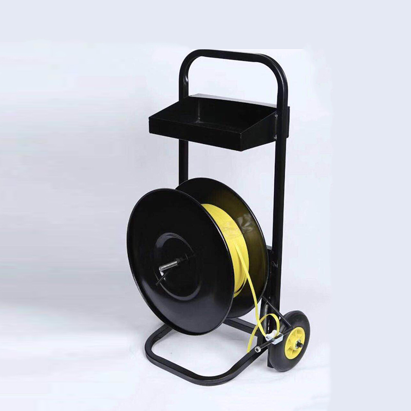 Black wheeled strapping dispenser with a yellow strap roll and upper tool tray.