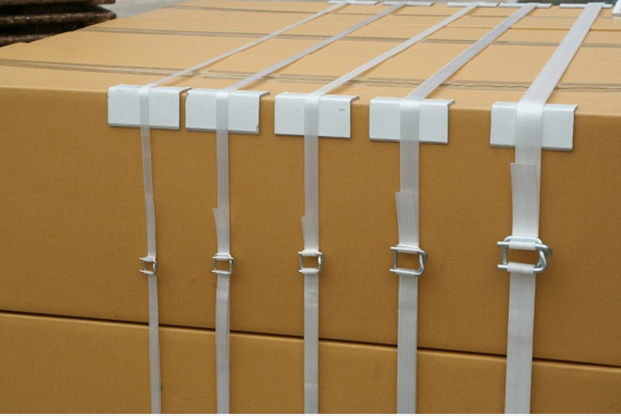 Cardboard cartons secured with white strapping, wire buckles and edge protectors.